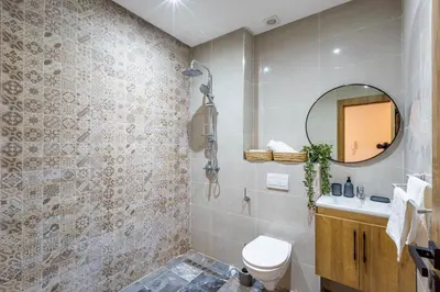 a bathroom with a toilet and a mirror at Marrakesh 2 BR Apartment in Marrakech