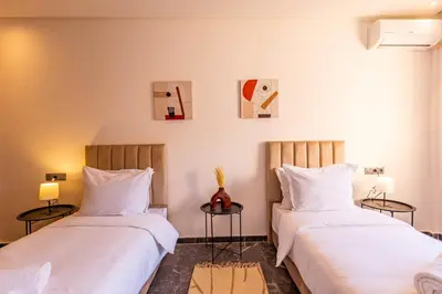 two beds sitting next to each other in a room at Marrakesh 2 BR Apartment in Marrakech