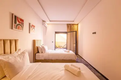 a hotel room with two beds and a window at Marrakesh 2 BR Apartment in Marrakech