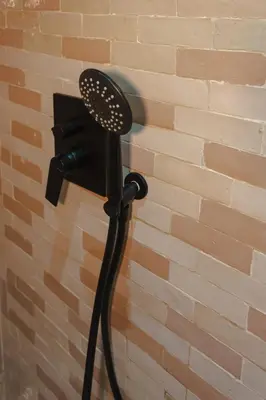 a shower head attached to a brick wall at Maison beldi loft in Marrakech