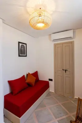 a room with a red couch and a ceiling at Maison beldi loft in Marrakech