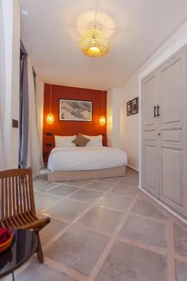 a bedroom with a bed and a chandelier at Maison beldi loft in Marrakech
