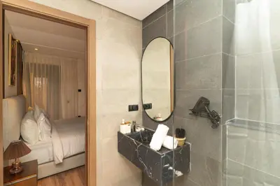 a bathroom with a sink and a mirror at Gueliz - Pool & Jacuzzi - Luxury Residence in Marrakech