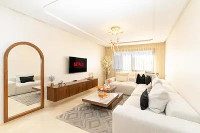 a living room with a white couch and a mirror at Gueliz - Pool & Jacuzzi - Luxury Residence in Marrakech