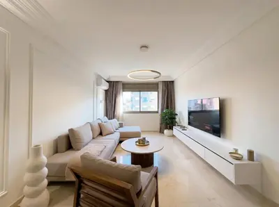 a living room with a couch and a tv at Modern & Luxurious Apartment, Terrace with panoramic view of Gueliz in Marrakech