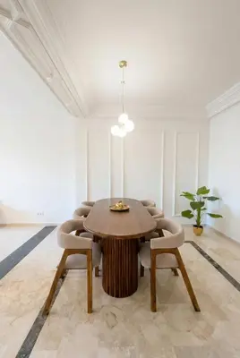 a dining room with a wooden table and chairs at Modern & Luxurious Apartment, Terrace with panoramic view of Gueliz in Marrakech