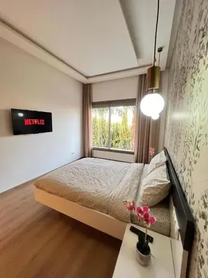 a small bedroom with a bed and a window at Villa luxe, tranquillité aux portes de Marrakech in Marrakech