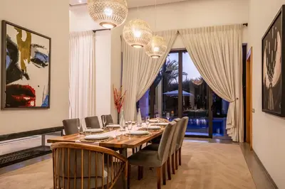 a dining room with a long table and chairs at Resort Batoul nor marrakech in Marrakech