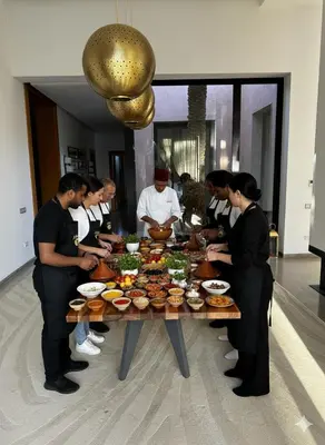 a group of people standing around a table with food at Resort Batoul nor marrakech in Marrakech
