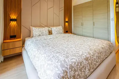 a bedroom with a large white bed with two pillows at Marrakech golf Prestigia Jade in Marrakech