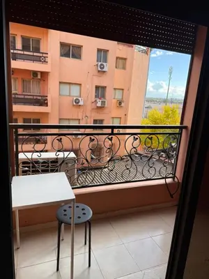 a balcony with a table and a view of a building at Hivernage Marrakech in Marrakech