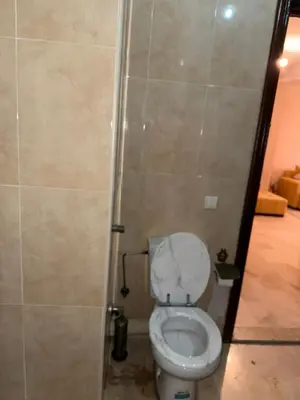 a bathroom with a white toilet in a stall at Hivernage Marrakech in Marrakech