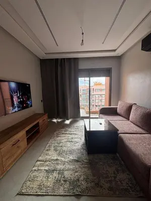 a living room with a couch and a flat screen tv at Studio Nahellan in Marrakech