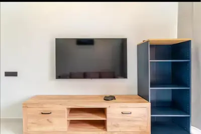 a wooden entertainment center with a tv on a wall at Studio Nahellan in Marrakech