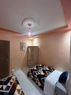 a bedroom with a bed and a ceiling at Aljawhara 2BD in Marrakech