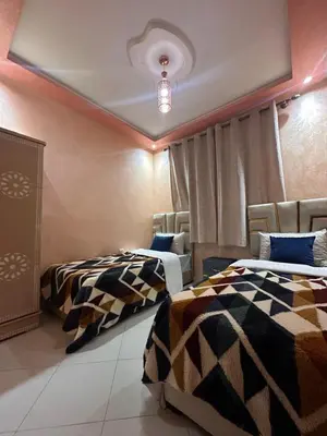a room with two beds and a ceiling at Aljawhara 2BD in Marrakech