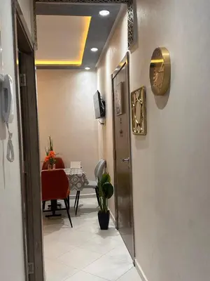 a hallway with a room with a table with a chair at Aljawhara 2BD in Marrakech