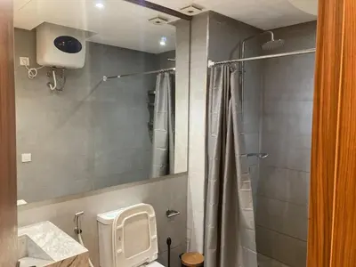 a bathroom with a shower with a toilet and a sink at Perfect condo for tourists in semlalia in Marrakech