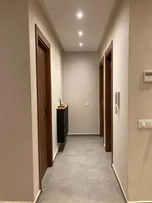a hallway with two doors and a television in a room at Perfect condo for tourists in semlalia in Marrakech