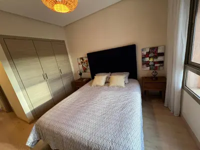 a bedroom with a bed with two pillows on it at 2 chambre Prestigia Jade golf city in Marrakech