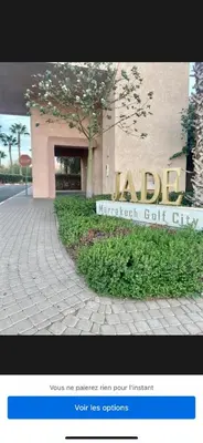 a sign in front of a building at 2 chambre Prestigia Jade golf city in Marrakech
