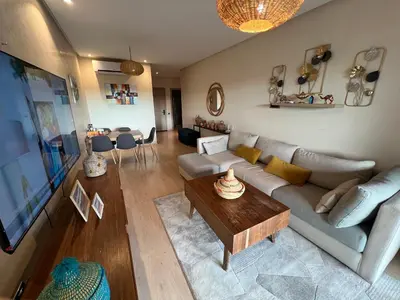 an overhead view of a living room with a couch and a table at 2 chambre Prestigia Jade golf city in Marrakech