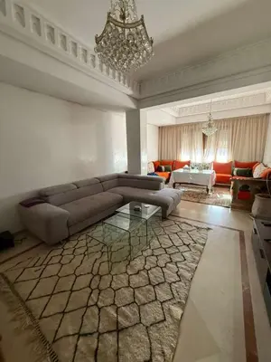 a living room with a couch and a chandelier at Central Gueliz 2Bedroom Apartment in Marrakech