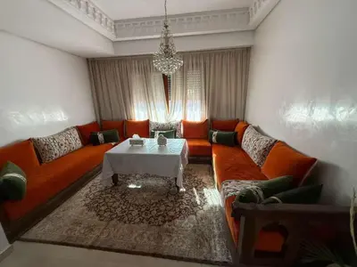 a living room with orange couches and a table at Central Gueliz 2Bedroom Apartment in Marrakech