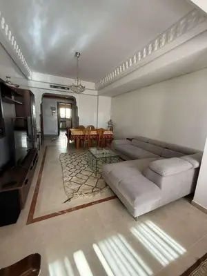 a living room with a couch and a table at Central Gueliz 2Bedroom Apartment in Marrakech