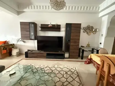 a living room with a fireplace and a glass table at Central Gueliz 2Bedroom Apartment in Marrakech