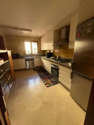 a kitchen with a refrigerator and a counter top at Central Gueliz 2Bedroom Apartment in Marrakech
