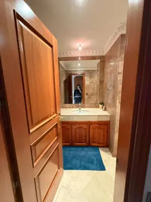 a bathroom with a tub and a sink and a door at Central Gueliz 2Bedroom Apartment in Marrakech