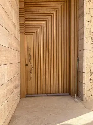 a wooden door in a building with at Villa Familiale - Idéale pour Groupe jusqu'à 10 Personnes in Marrakech