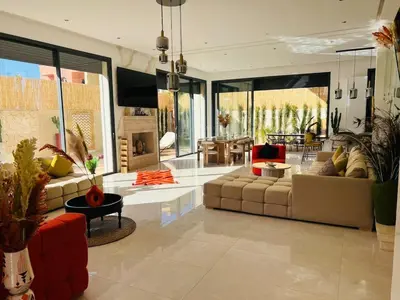 a large living room with couches and a table at Villa Familiale - Idéale pour Groupe jusqu'à 10 Personnes in Marrakech