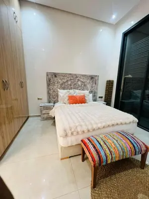 a bedroom with a large bed with orange pillows at Villa Familiale - Idéale pour Groupe jusqu'à 10 Personnes in Marrakech