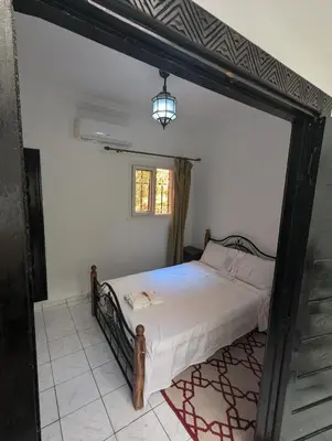 a bedroom with a bed and a window at Riad absar in Marrakech