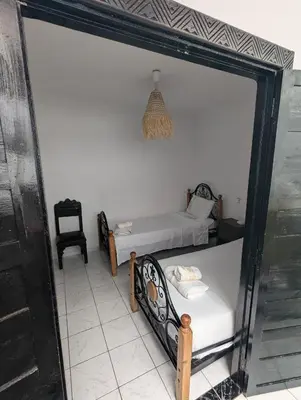 a room with two beds and a mirror at Riad absar in Marrakech
