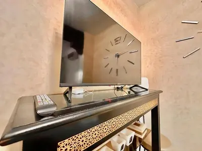 a clock on a table with a mirror on it at Elegant Cocoon 2 Bedrooms, Pool & Rooftop in Marrakech