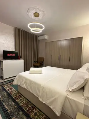 a hotel room with a large bed and a television at Marrakech Airport in Marrakech