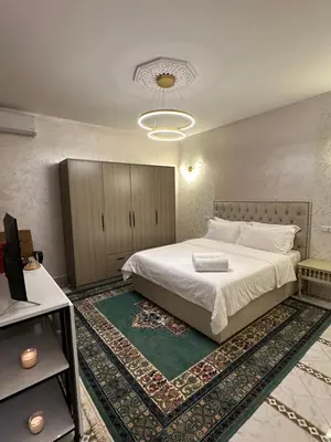 a bedroom with a large white bed with a rug at Marrakech Airport in Marrakech