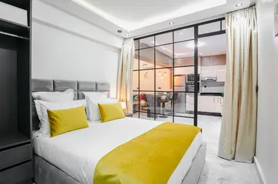 a bedroom with a large bed with yellow pillows at Pause in the City - Duplex - Marrakech Centre in Marrakech