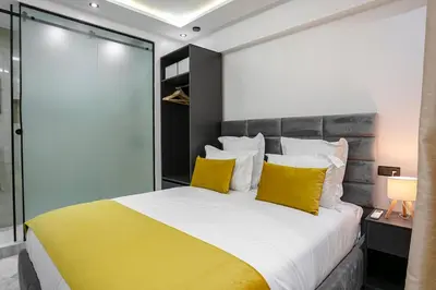 a bedroom with a large bed with yellow pillows at Pause in the City - Duplex - Marrakech Centre in Marrakech