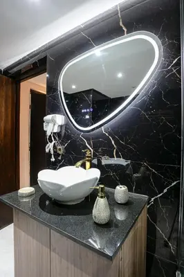 a bathroom with a sink and a mirror on a counter at Pause in the City - Duplex - Marrakech Centre in Marrakech