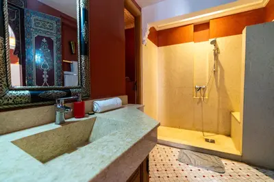 a bathroom with a shower and a sink and a tub at Palais Nejma - Locanda Boutique Collection in Marrakech