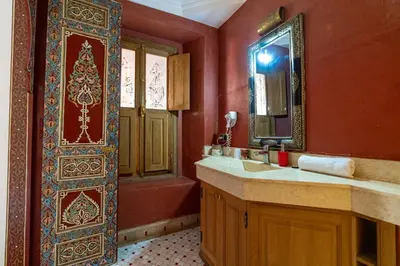 a bathroom with a sink and a mirror at Palais Nejma - Locanda Boutique Collection in Marrakech