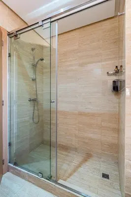 a shower with a glass door in a bathroom at Prestigia Opale - Superb condo with Golf & Pool views in Marrakech
