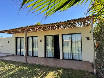 a small house with a wooden porch at Bungalow in Marrakech in Marrakech