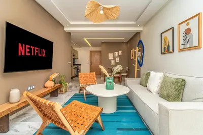 a living room with a couch and a table at Appartement Romantique et Moderne a Gueliz in Marrakech