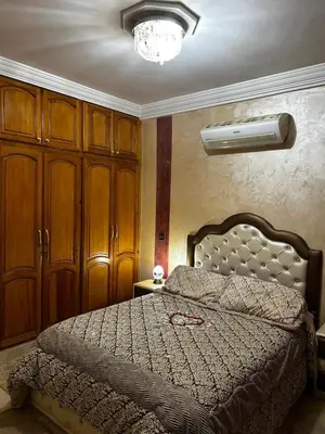 a bedroom with a bed and a fan at Riad Dar Kenza in Marrakech