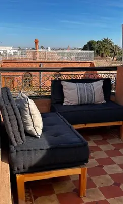 two couches sitting on top of a balcony at Riad Dar Kenza in Marrakech